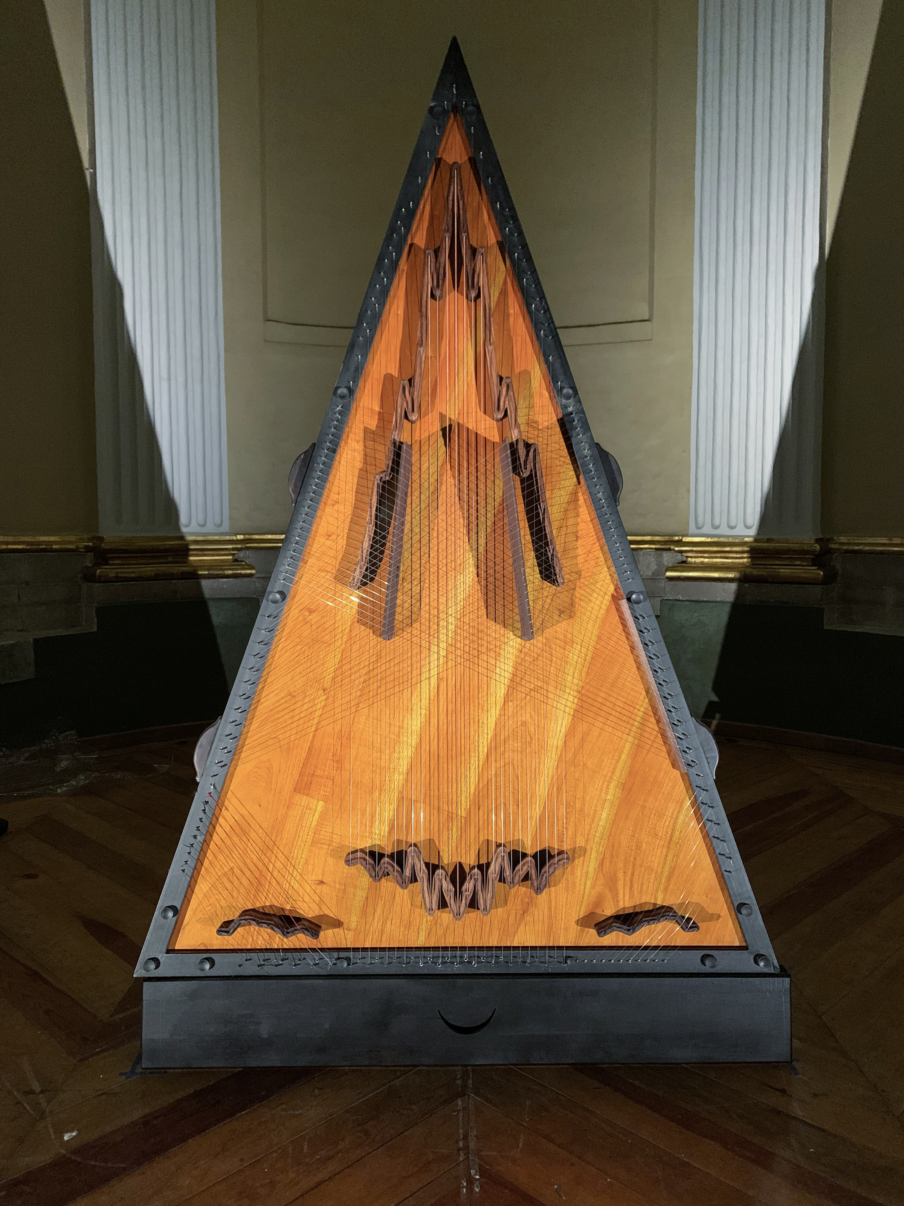 Citrapataṃga Brevicornis, 2022.  
Ximena Labra, Leonardo Heiblum. Collaboration with luthier Carlos Chinchillas.
Instrumento musical para 12 manos, escultura sonora. Tabla armónica: madera de cedro con puentes tallados de chagane. 108 cuerdas: piano, arpa de concierto, arpa jarocha,  jarana, sitar, y salterio. Cuerpo: maderas de chechen y katalox, herrería y acero. 

Musical instrument for twelve hands, sound sculpture. Harmonic table: cedar wood with carved chagane wood bridges. 108 strings: piano, concert harp, Jarocha harp, jarana, sitar and psaltery strings. Body: chechen and katalox woods. Iron and steel. 
2.7 x 1.8 x 1.3 m 
